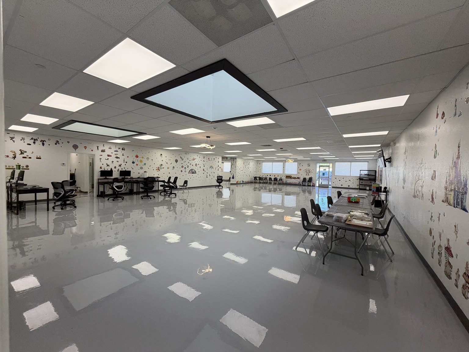 Spacious main activity room with tables and seating